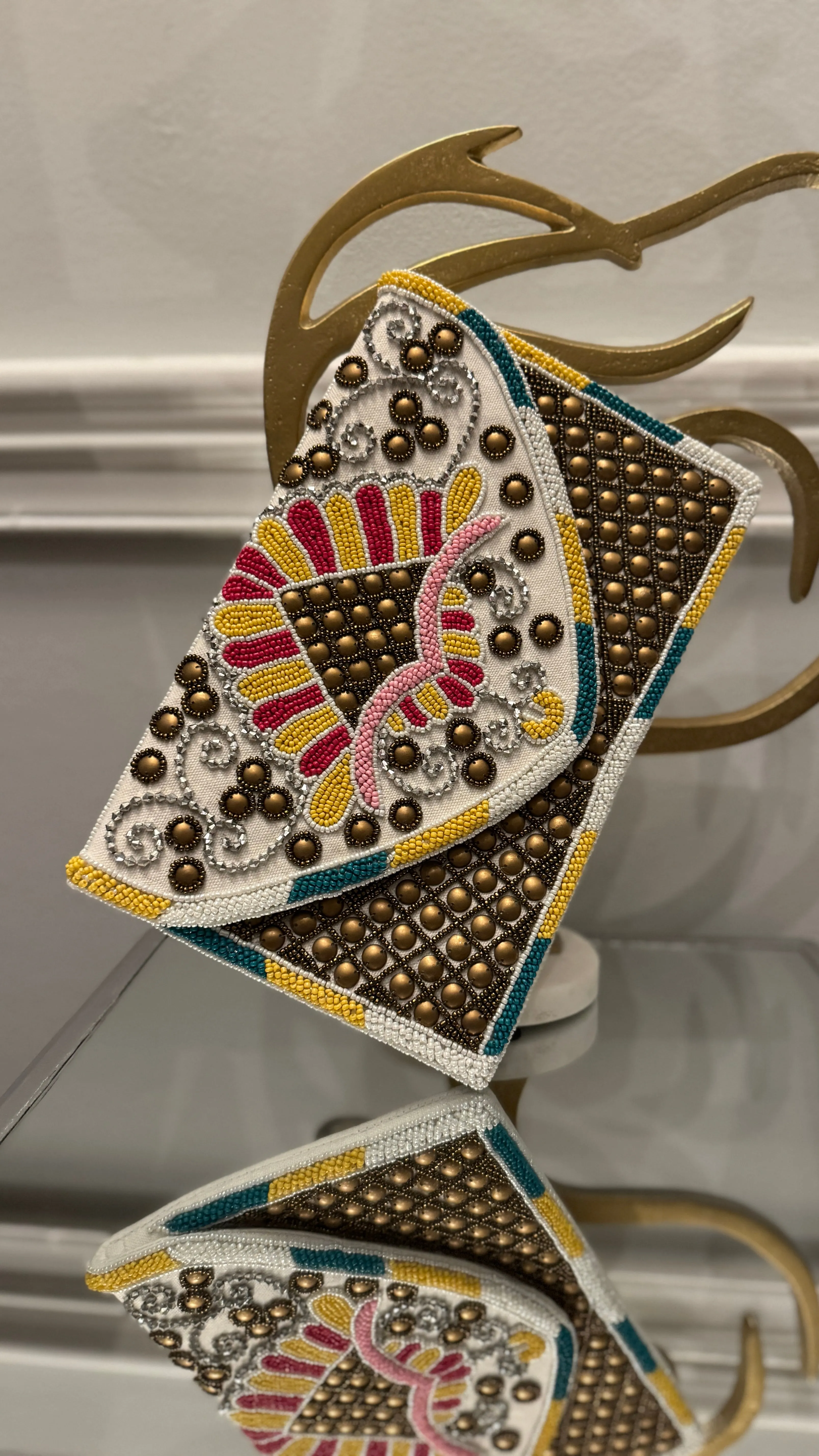 Hand beaded multi-colored with bronze studs clutch